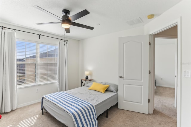 bedroom with light carpet and ceiling fan