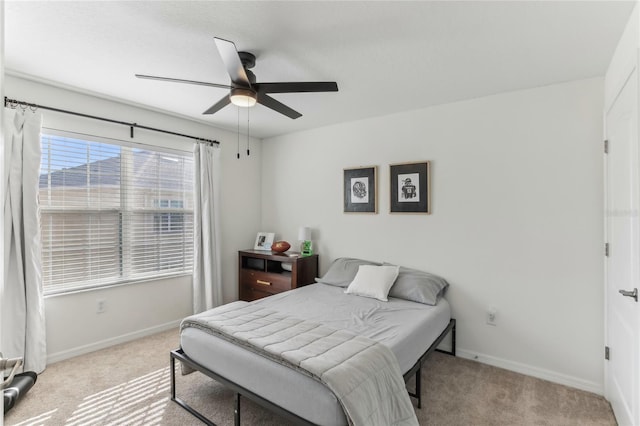 bedroom featuring ceiling fan and light colored carpet