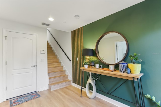 foyer entrance with light hardwood / wood-style floors