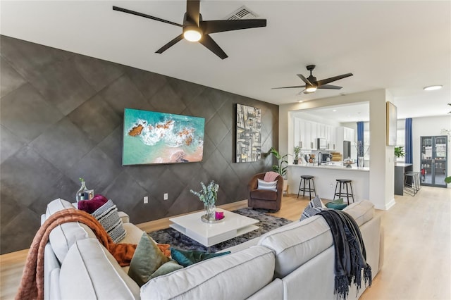 living room with hardwood / wood-style flooring and ceiling fan