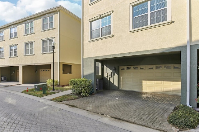 view of property featuring central AC and a garage