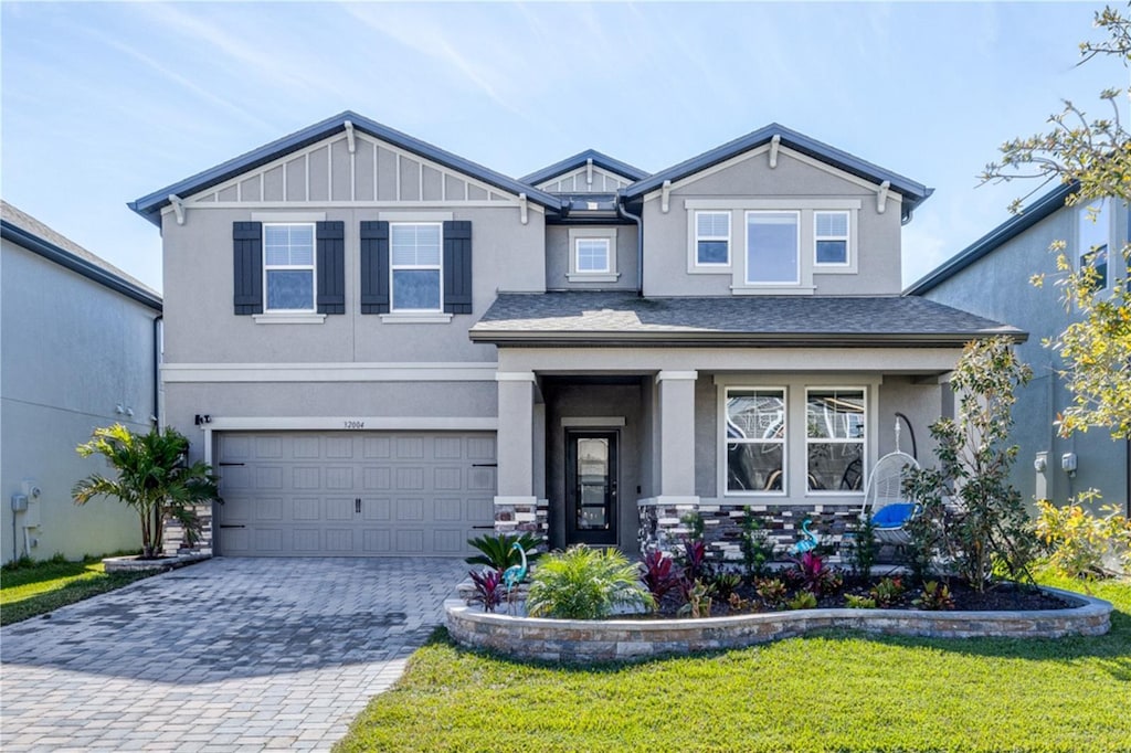 view of front of home featuring a garage and a front lawn