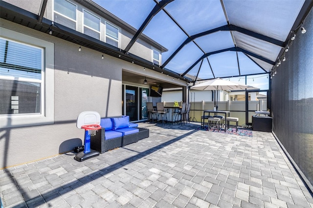 view of patio featuring an outdoor living space, glass enclosure, and exterior bar