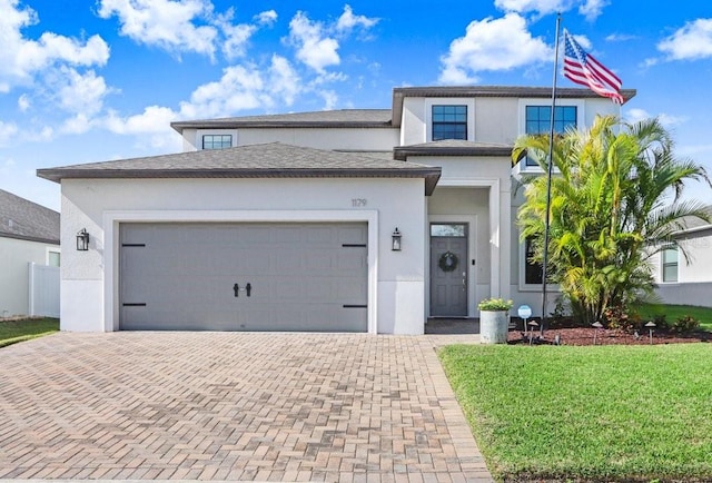 view of front of house featuring a garage and a front lawn