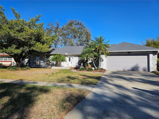 ranch-style house with a garage and a front yard