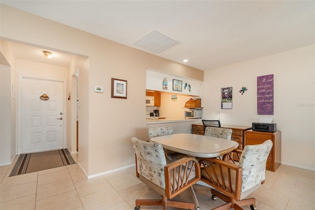 dining area featuring light tile patterned flooring