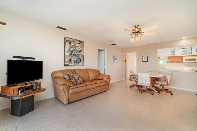 living room with ceiling fan and light tile patterned floors