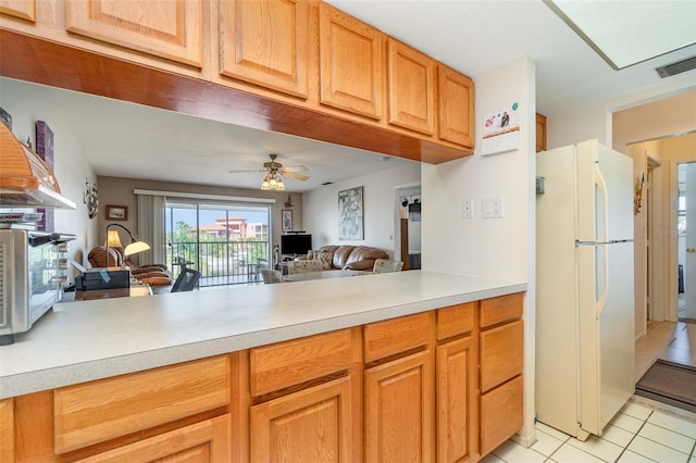 kitchen featuring white refrigerator, light tile patterned floors, and ceiling fan