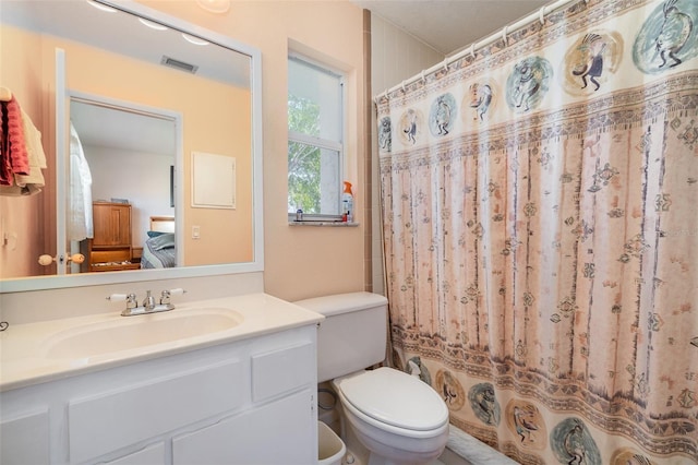 bathroom with vanity, a shower with shower curtain, and toilet