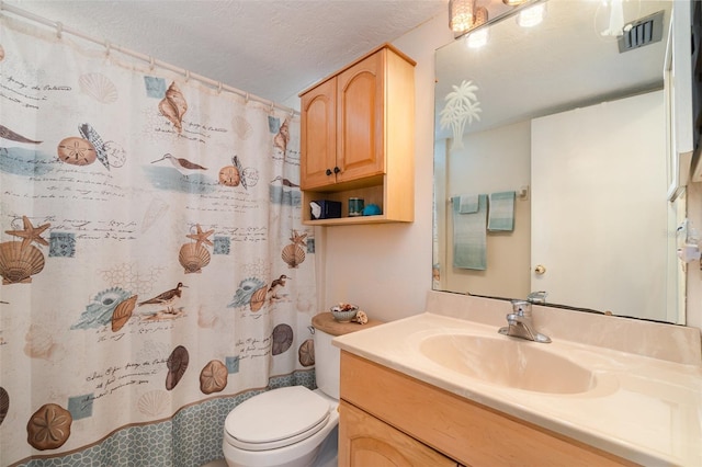 bathroom with vanity, a shower with shower curtain, a textured ceiling, and toilet