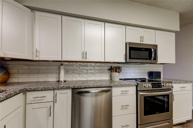 kitchen with stainless steel appliances and white cabinets