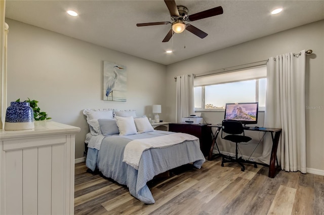 bedroom with hardwood / wood-style flooring and ceiling fan