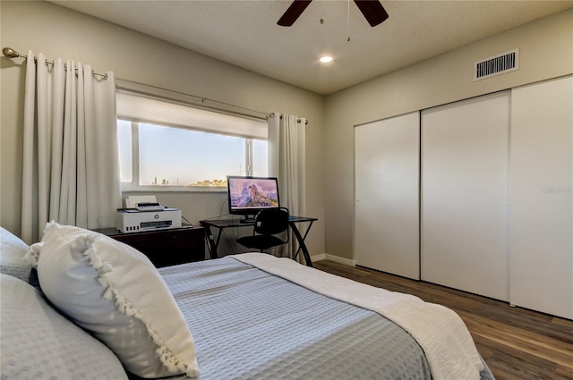 bedroom featuring dark wood-type flooring, ceiling fan, and a closet