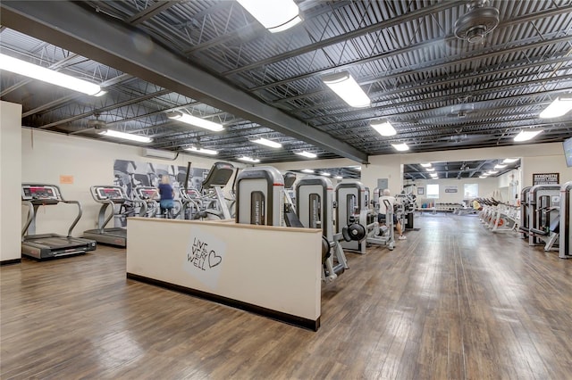 exercise room with hardwood / wood-style flooring