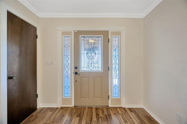 foyer with light hardwood / wood-style flooring and ornamental molding