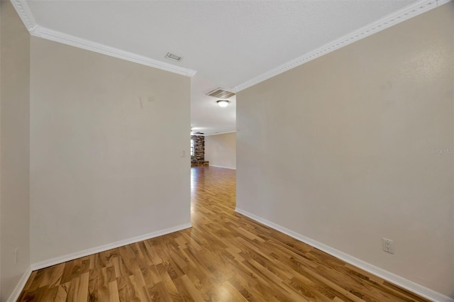 unfurnished room featuring crown molding and light hardwood / wood-style flooring