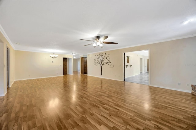 unfurnished room with ceiling fan with notable chandelier, wood-type flooring, and ornamental molding