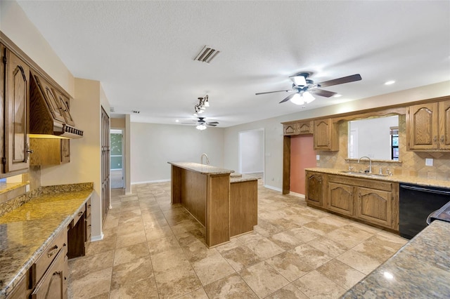 kitchen with a healthy amount of sunlight, sink, backsplash, and black dishwasher