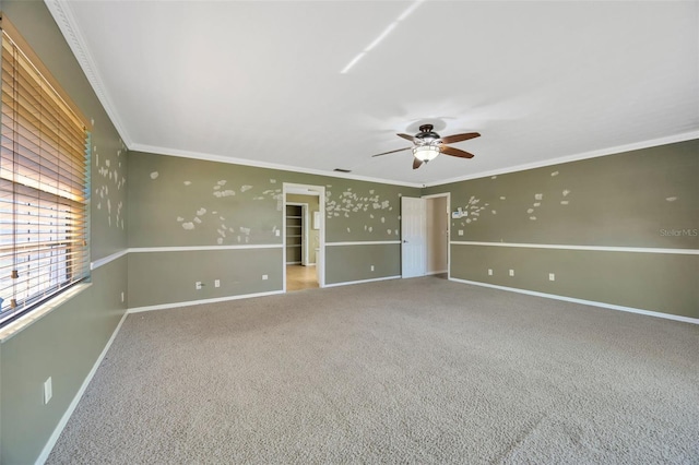 carpeted empty room featuring crown molding and ceiling fan