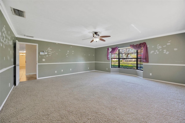 spare room featuring crown molding, ceiling fan, and carpet flooring