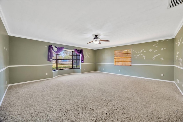 spare room with ornamental molding, ceiling fan, and carpet