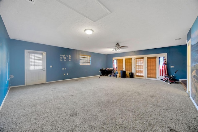 interior space featuring ceiling fan, carpet flooring, and a textured ceiling