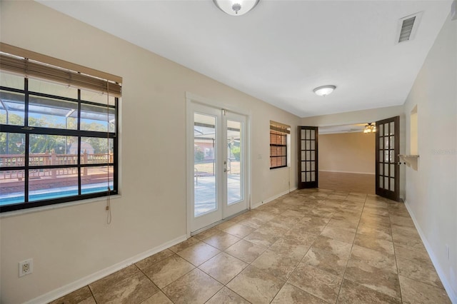 hallway featuring french doors and plenty of natural light