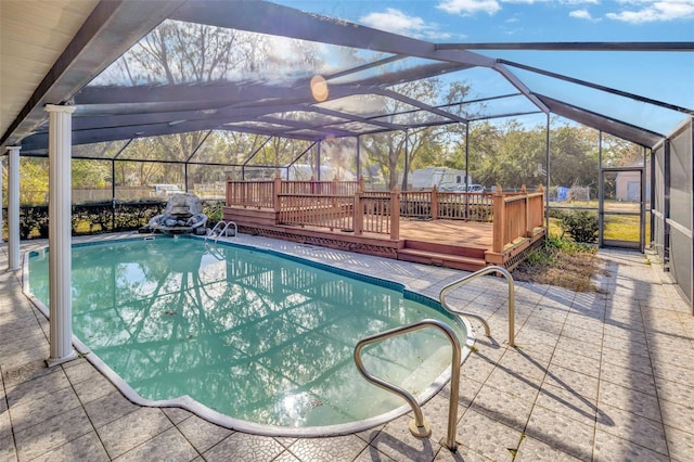 view of pool with a lanai, a patio area, and a deck