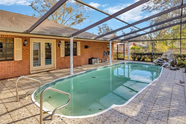 view of pool featuring a patio area, french doors, and glass enclosure