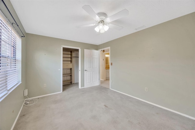 unfurnished bedroom with light colored carpet, ceiling fan, and a closet