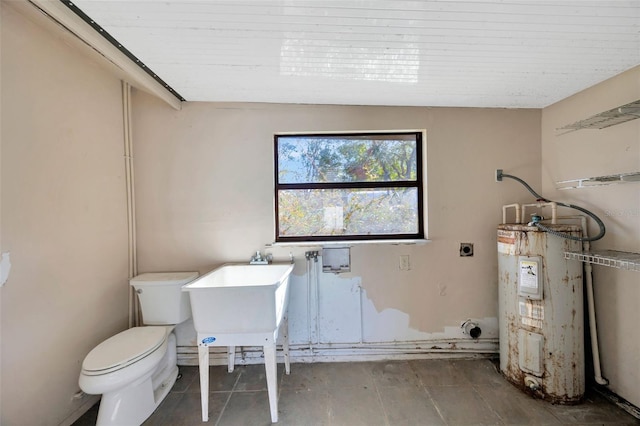 bathroom with toilet, sink, and water heater