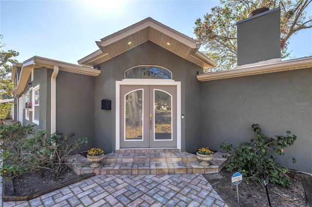 view of exterior entry featuring french doors