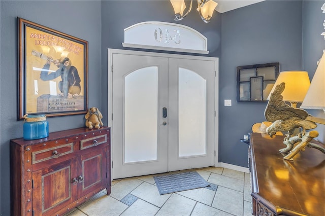 entrance foyer with a notable chandelier and french doors