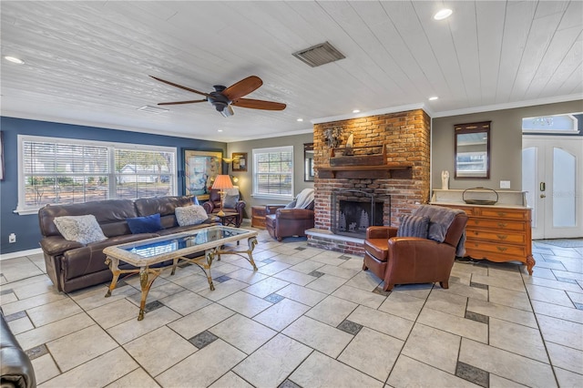 tiled living room with crown molding, ceiling fan, wood ceiling, and a fireplace