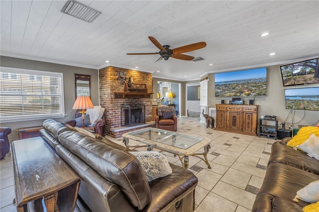 living room featuring ornamental molding, light tile patterned floors, ceiling fan, and a fireplace