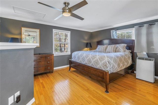 bedroom featuring light hardwood / wood-style flooring, ornamental molding, and ceiling fan