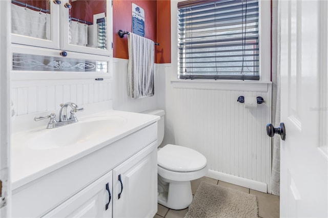 bathroom with vanity, tile patterned flooring, and toilet