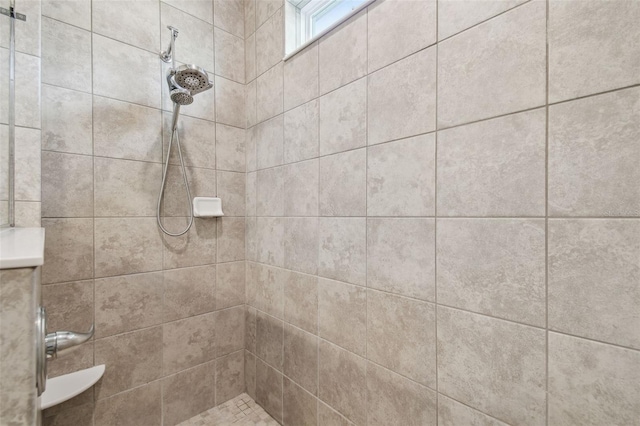 bathroom with tiled shower