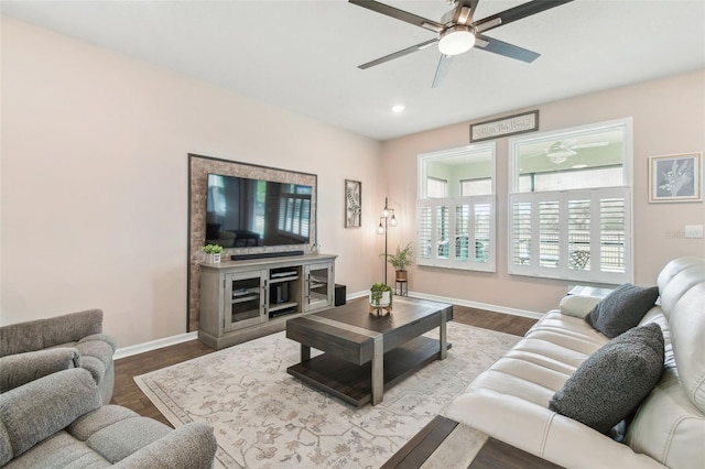 living room featuring hardwood / wood-style floors and ceiling fan