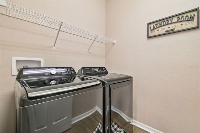 laundry room featuring hardwood / wood-style floors and washer and clothes dryer