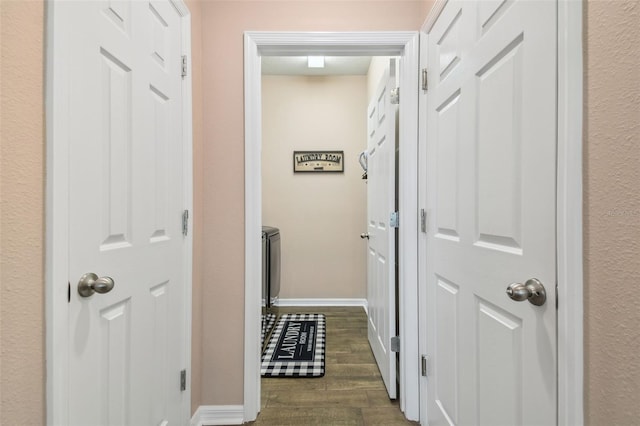 hall with dark hardwood / wood-style flooring