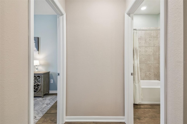 hall with dark hardwood / wood-style flooring