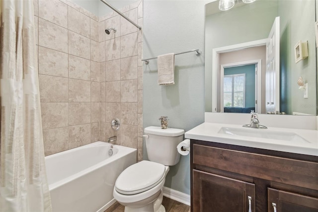 full bathroom featuring shower / tub combo with curtain, vanity, and toilet