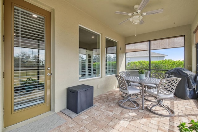 sunroom featuring ceiling fan