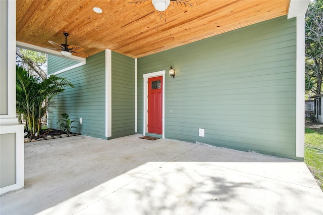 view of exterior entry with a patio and ceiling fan