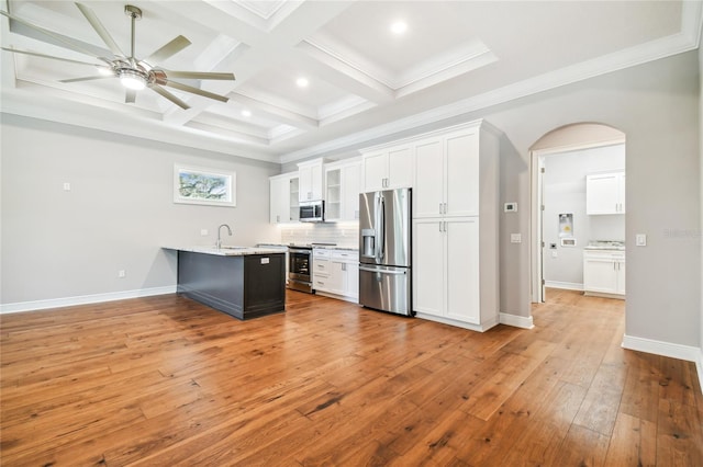 kitchen with coffered ceiling, sink, white cabinetry, light hardwood / wood-style flooring, and stainless steel appliances