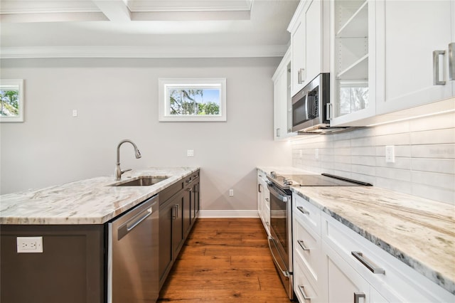 kitchen with light stone counters, sink, white cabinets, and appliances with stainless steel finishes