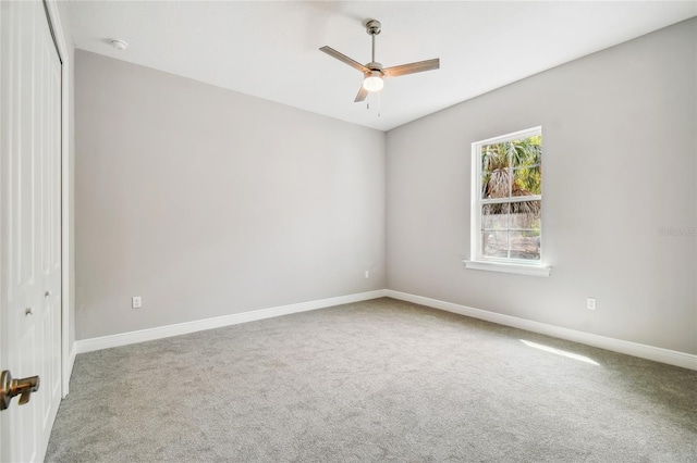 carpeted empty room featuring ceiling fan