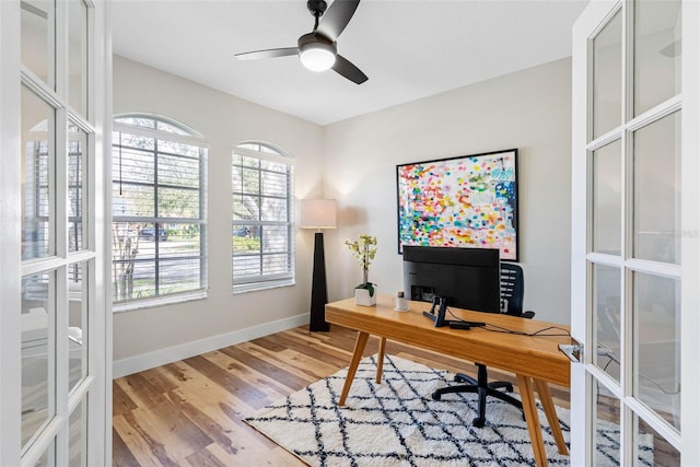 office featuring ceiling fan, light hardwood / wood-style floors, and french doors