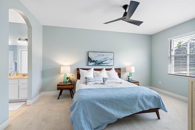 carpeted bedroom featuring ceiling fan and ensuite bathroom